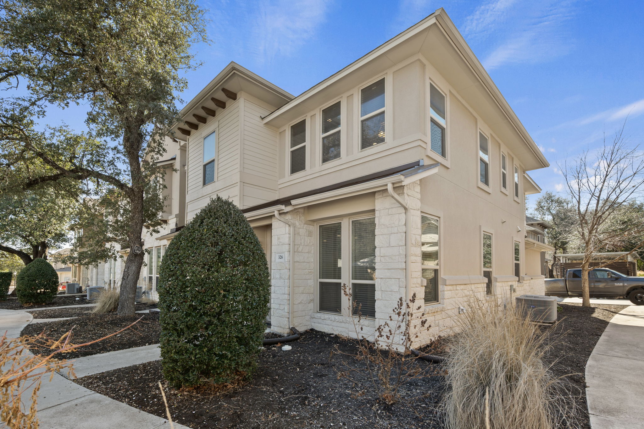 13800 Lyndhurst Street, Unit 326 Austin, TX 78717 - Photo 2 of 39 a front view of a house with garden