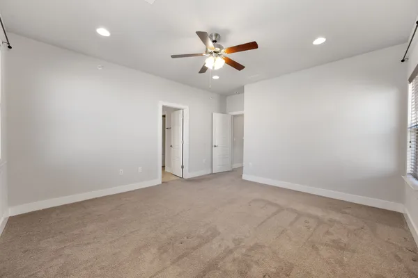 a spacious bathroom with a double vanity sink a large mirror and shower