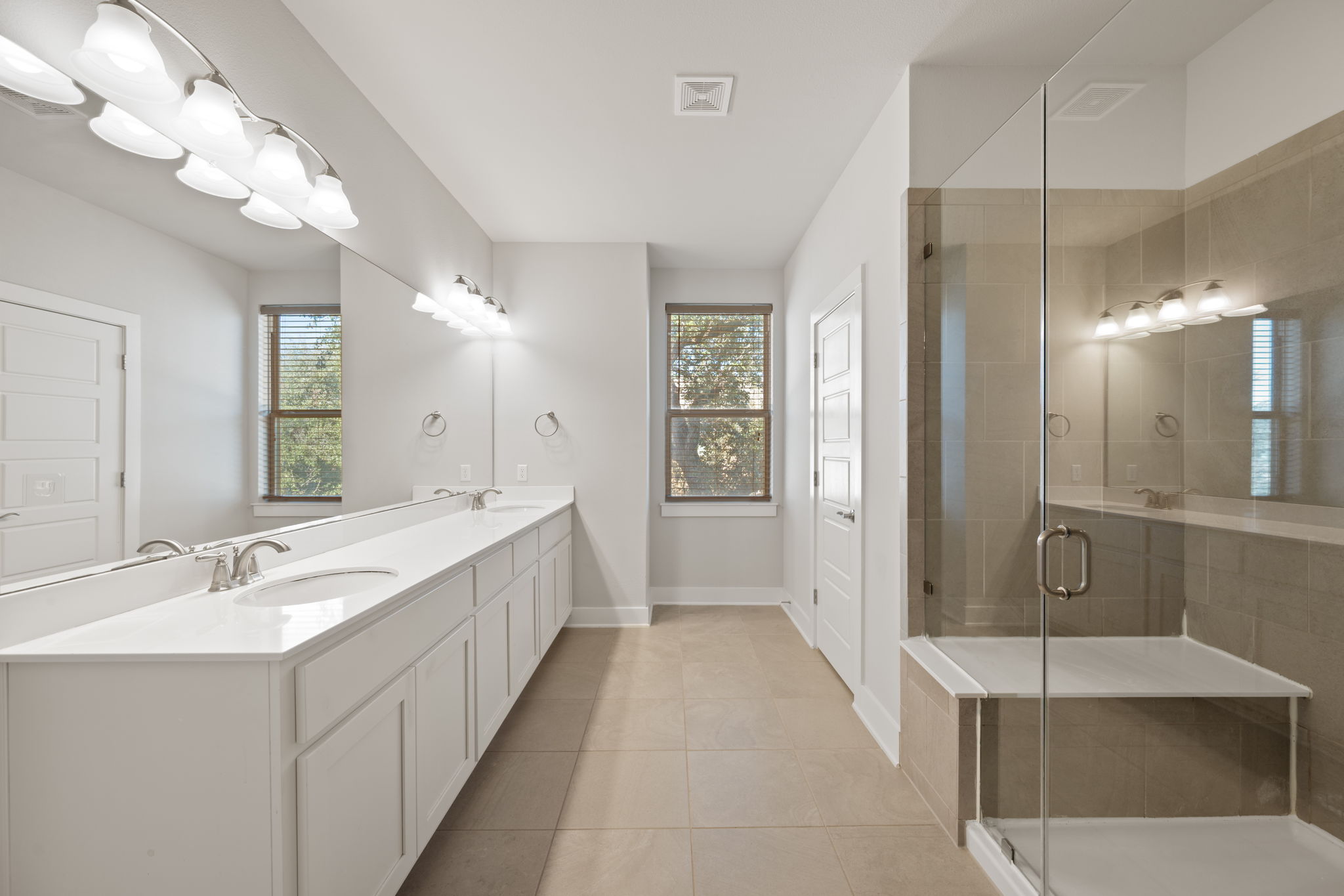 13800 Lyndhurst Street, Unit 326 Austin, TX 78717 - Photo 22 of 39 a spacious bathroom with a double vanity sink a large mirror and shower