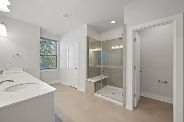 a bathroom with a double vanity sink and a mirror