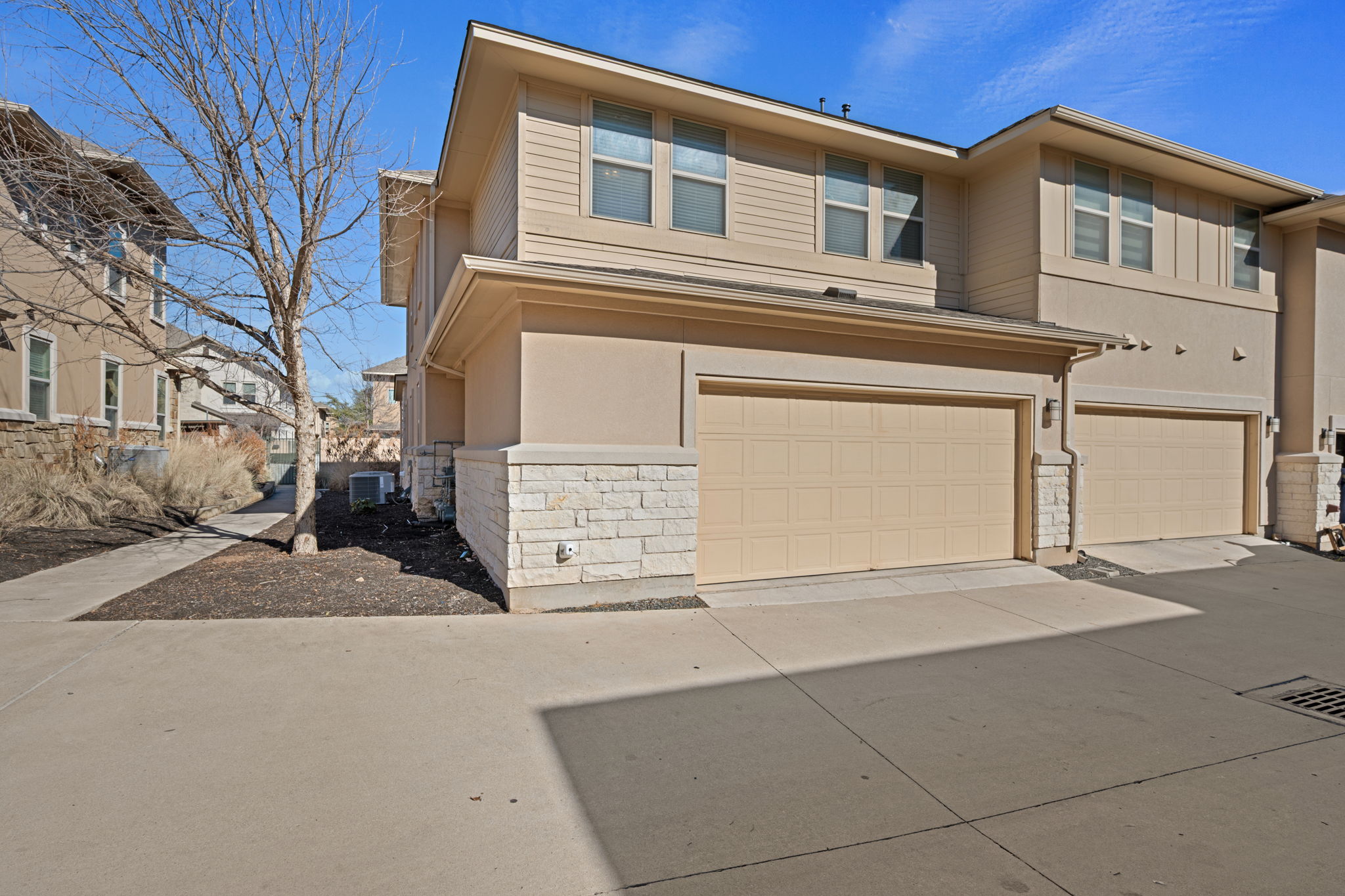 13800 Lyndhurst Street, Unit 326 Austin, TX 78717 - Photo 33 of 39 a front view of a house with a garage