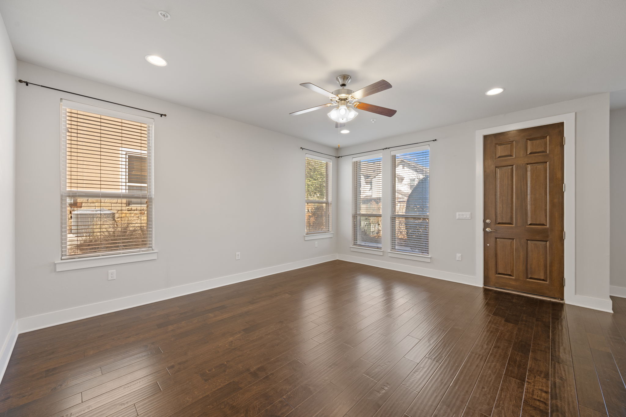 13800 Lyndhurst Street, Unit 326 Austin, TX 78717 - Photo 6 of 39 a view of an empty room with a window and wooden floor