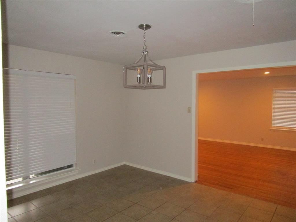 7128 Clemson Drive Dallas, TX 75214 - Photo 4 of 10 an empty room with windows