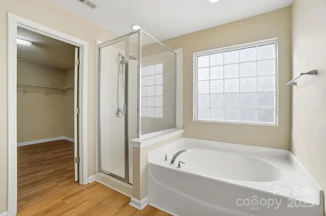 a bathroom with a bathtub and a shower