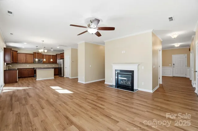 a view of a kitchen with a sink and a fireplace