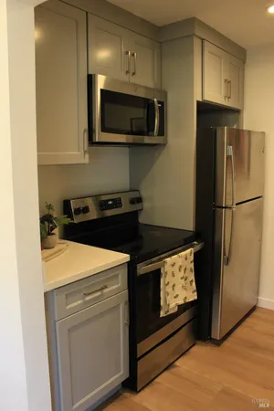 a kitchen with stainless steel appliances a stove a microwave and a refrigerator