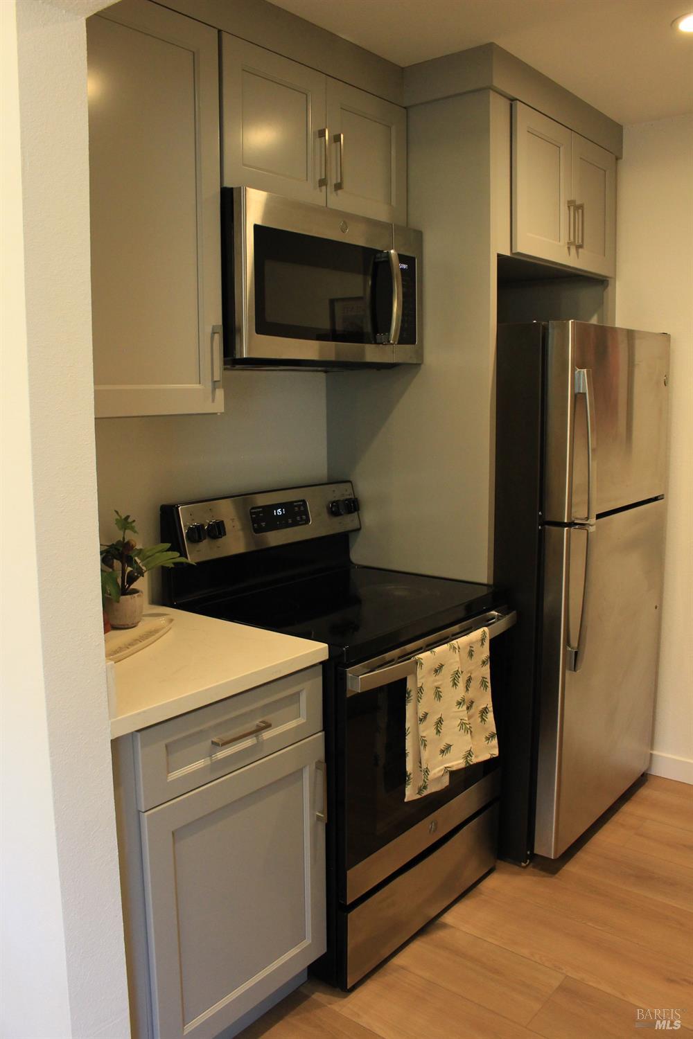 1347 Southwest Boulevard, Unit F Rohnert Park, CA 94928 - Photo 3 of 22 a kitchen with stainless steel appliances a stove a microwave and a refrigerator