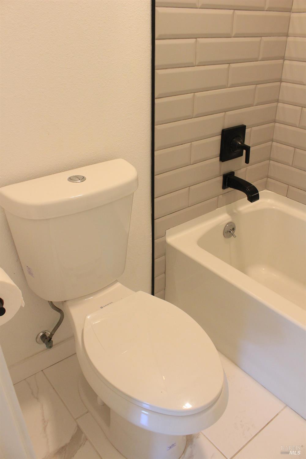1347 Southwest Boulevard, Unit F Rohnert Park, CA 94928 - Photo 9 of 22 a bathroom with a toilet and a bathtub