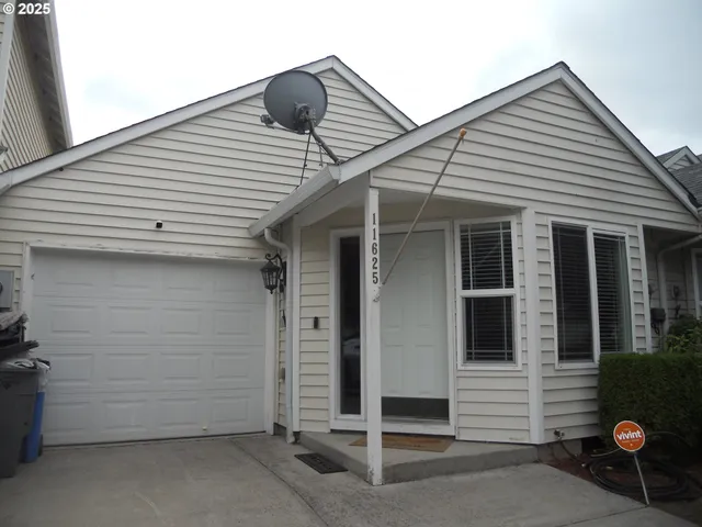 a view of a house with wooden fence