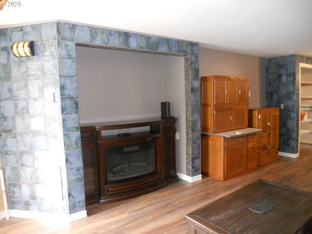 a kitchen with granite countertop a refrigerator stove and oven