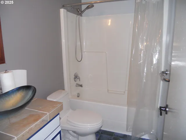 a white toilet sitting next to a bathroom sink