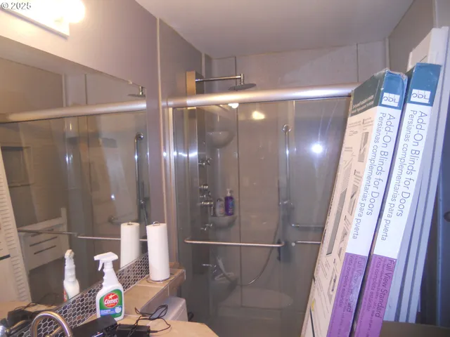 a bathroom with a mirror and a shower