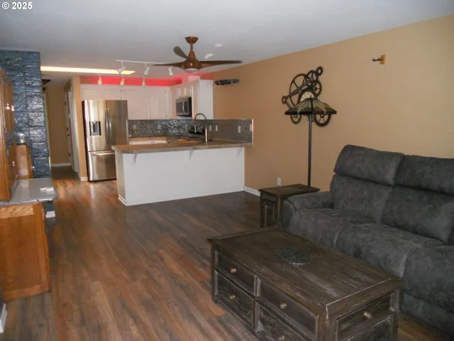 a living room with furniture and kitchen view