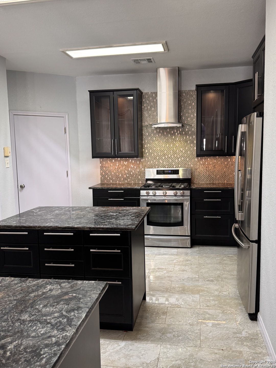 3836 Laurel Ridge Drive Round Rock, TX 78665 - Photo 11 of 40 a kitchen with stainless steel appliances granite countertop a stove a refrigerator and a sink