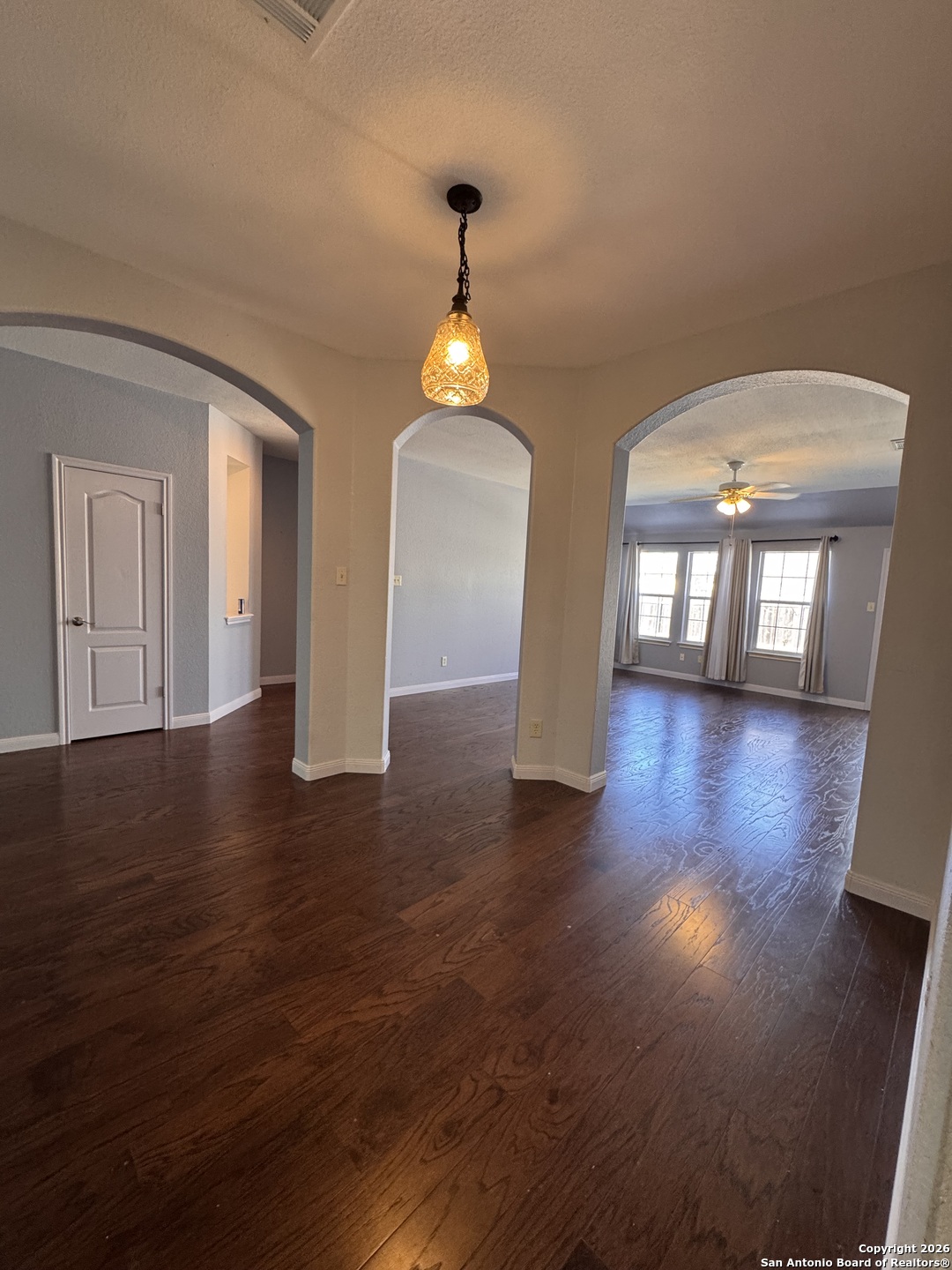 3836 Laurel Ridge Drive Round Rock, TX 78665 - Photo 15 of 40 a hallway with wooden floor chandelier and entryway