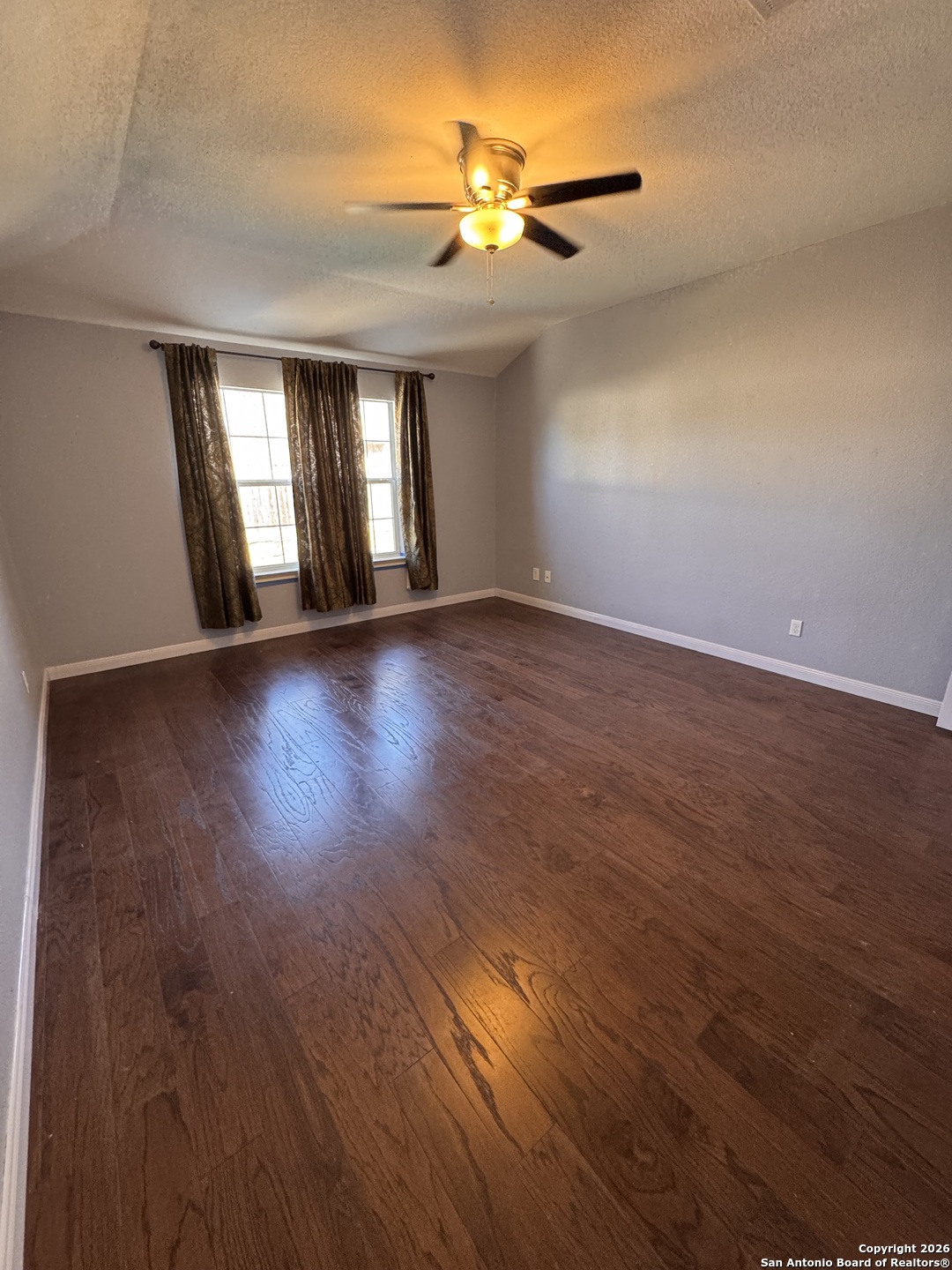 3836 Laurel Ridge Drive Round Rock, TX 78665 - Photo 20 of 40 a view of an empty room with wooden floor and a window
