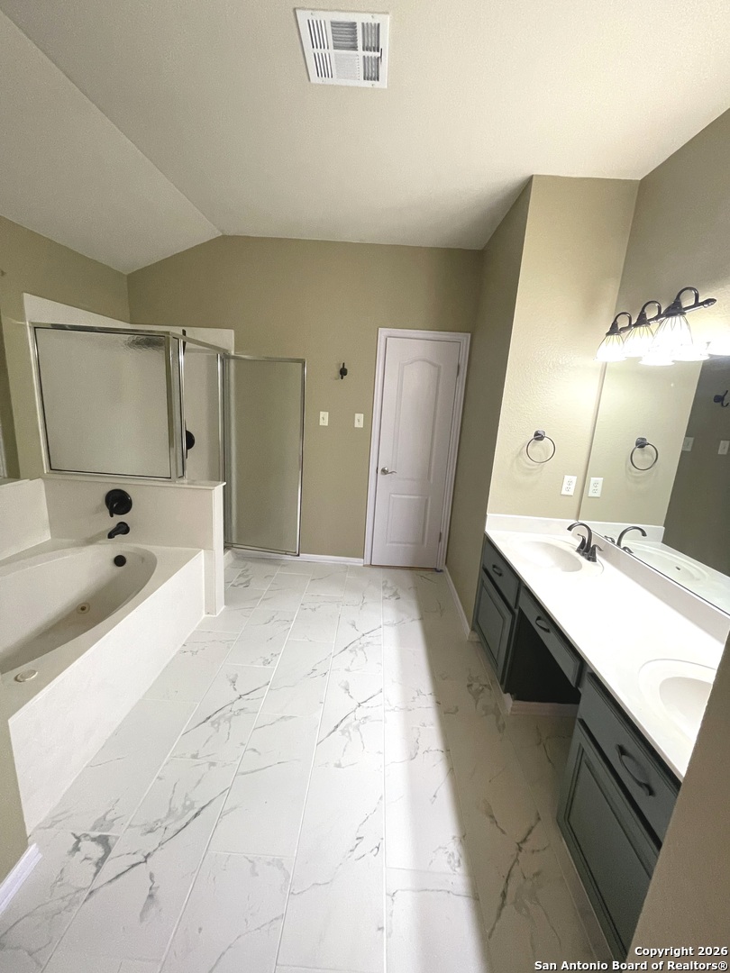 3836 Laurel Ridge Drive Round Rock, TX 78665 - Photo 22 of 40 a large bathroom with a tub sink and mirror