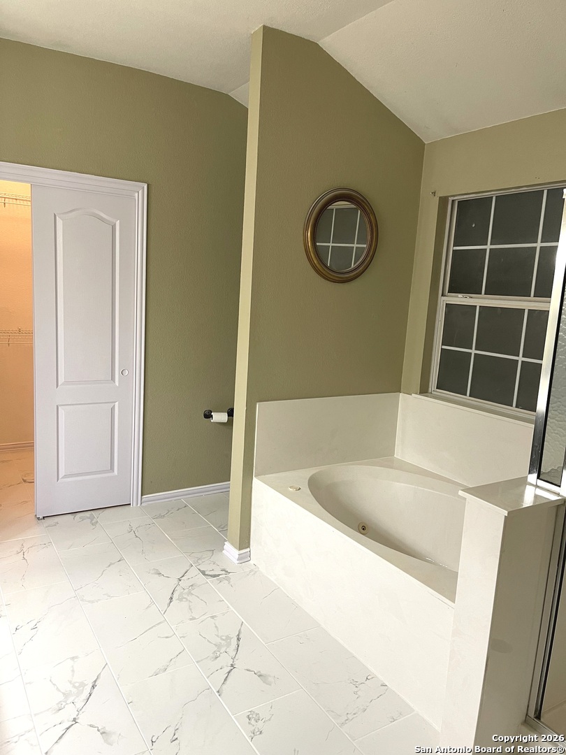 3836 Laurel Ridge Drive Round Rock, TX 78665 - Photo 25 of 40 a bathroom with a tub and a shower