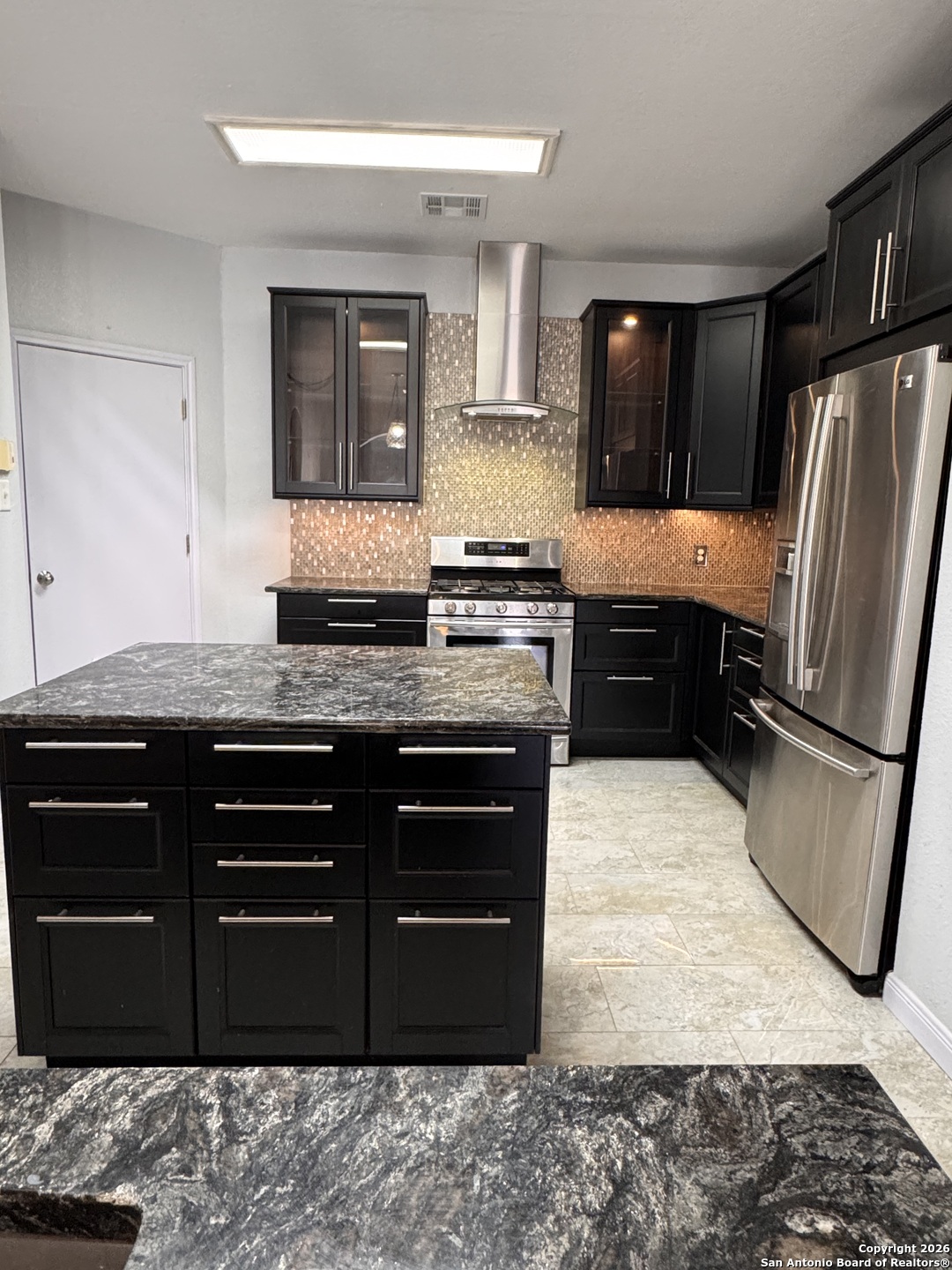3836 Laurel Ridge Drive Round Rock, TX 78665 - Photo 6 of 40 a kitchen with stainless steel appliances granite countertop a refrigerator and a stove