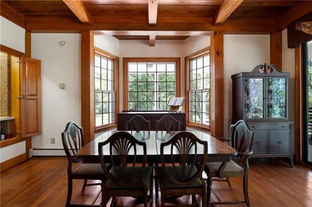 a dining room with furniture and wooden floor