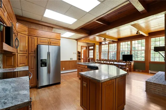 a bedroom with furniture and a large window