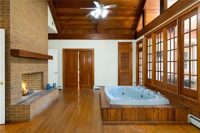 a bedroom with a bed chandelier and a window