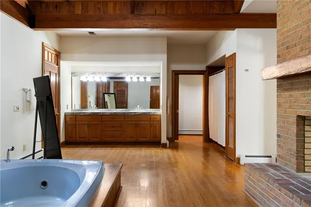 a spacious bathroom with a granite countertop sink and a mirror