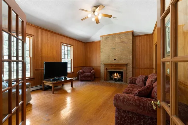 a front view of a house with a yard and trees