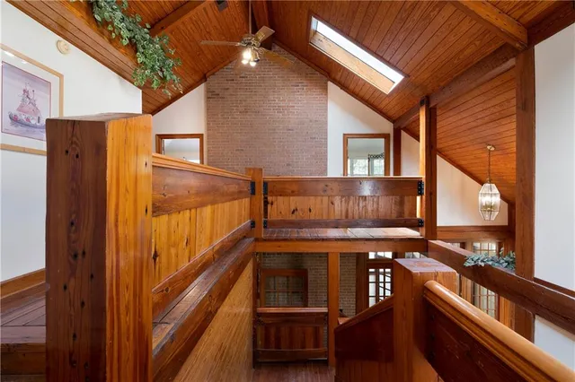 an aerial view of residential house with outdoor space and trees all around