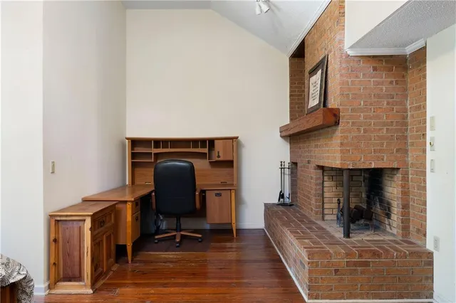 an aerial view of residential house with outdoor space and trees all around