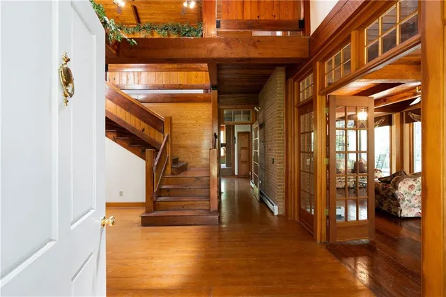 a view of an entryway with wooden floor and a livingroom