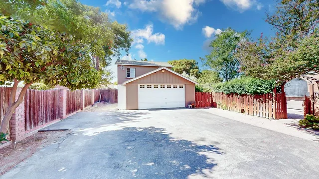 a living room with fireplace furniture and a large window