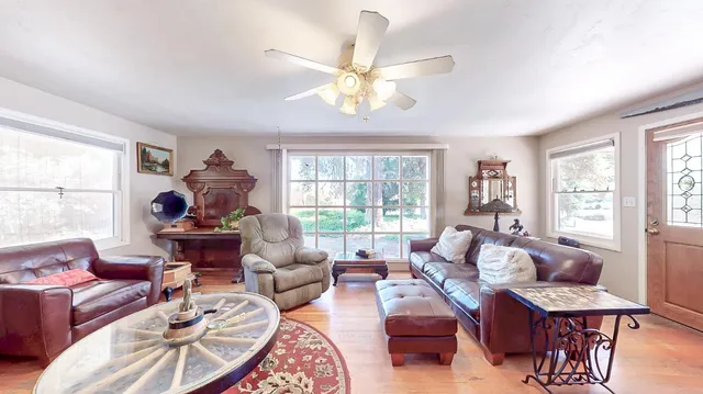 a living room with furniture and a wooden floor