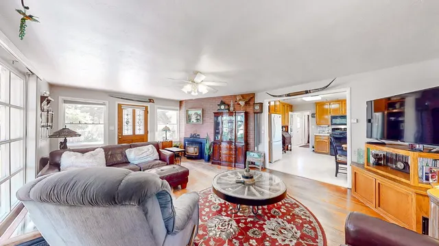 a dining room with furniture a chandelier and window