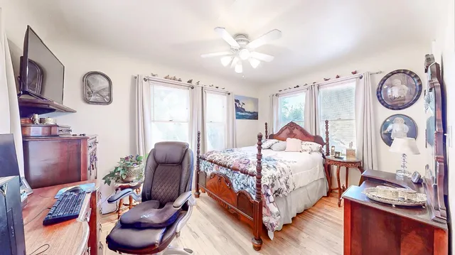 a view of a backyard with sitting area and potted plants