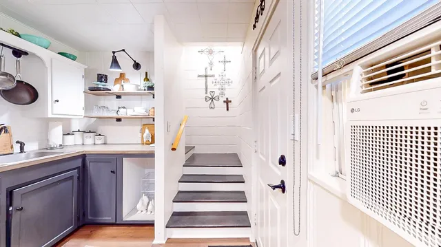 a bedroom with furniture and a flat screen tv