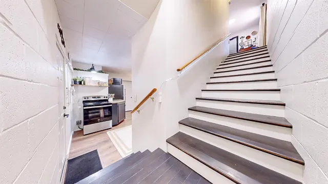 a bed sitting in a bedroom next to a lamp on a table