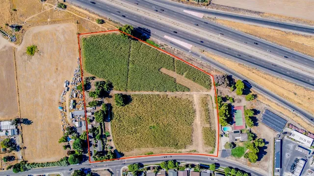 a view of backyard with seating area and green space
