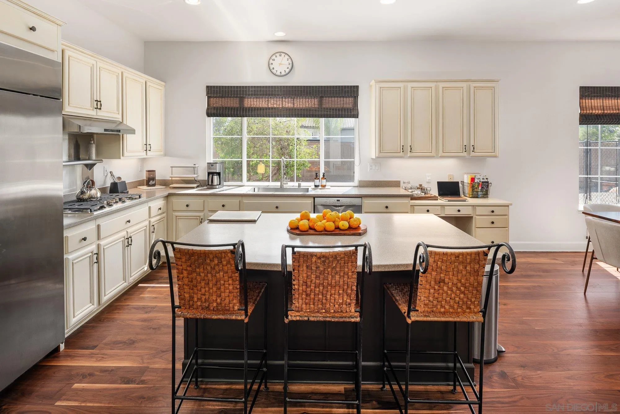 424 Sky Mesa Road Alpine, CA 91901 - Photo 27 of 75 a kitchen with stainless steel appliances granite countertop a stove a sink dishwasher a microwave oven and a dining table with wooden cabinet