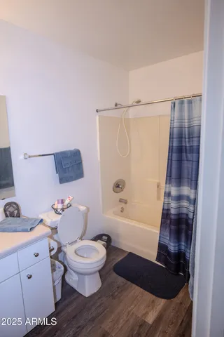 a bathroom with a granite countertop toilet sink and mirror