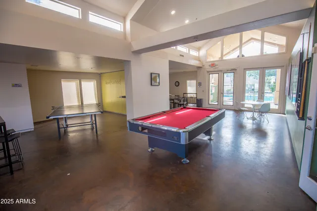 a large kitchen with a table and chairs