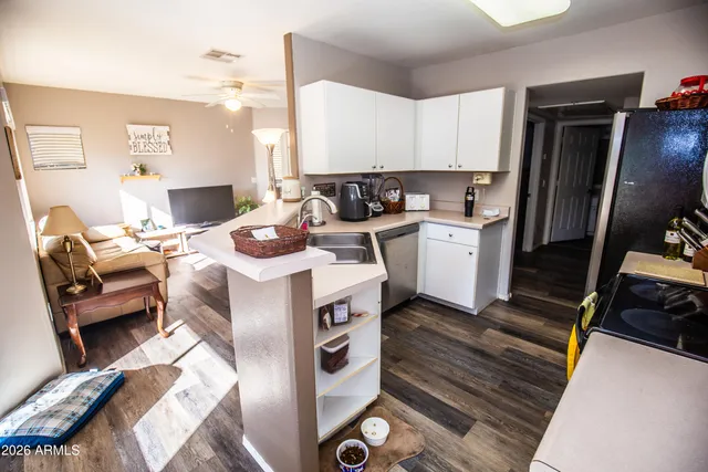 a kitchen with kitchen island granite countertop a sink dining table and chairs