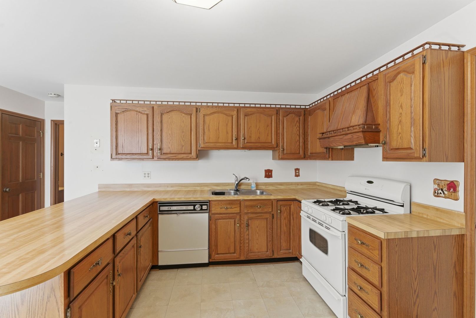 1356 Fifth Street Montgomery, IL 60538 - Photo 7 of 32 a kitchen with white cabinets sink and white appliances