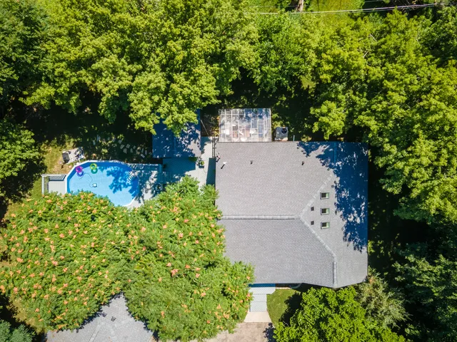 an aerial view of a house with a yard