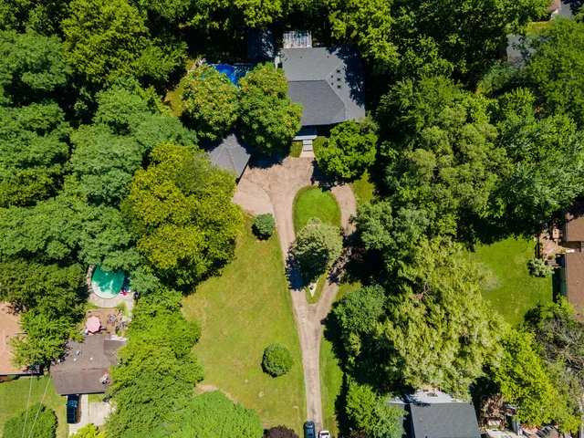 an aerial view of a house with yard