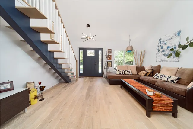 a living room with furniture and wooden floor