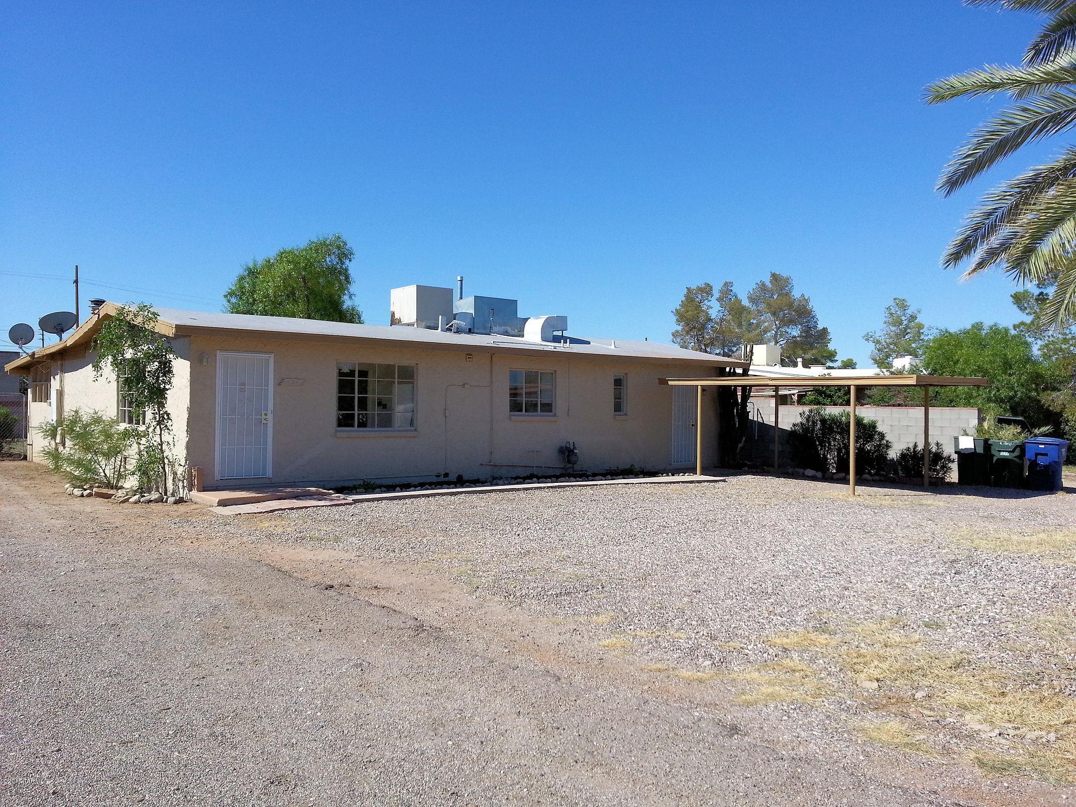 131 West Navajo Road Tucson, AZ 85705 - Photo 1 of 13 a front view of a house with a yard and garage