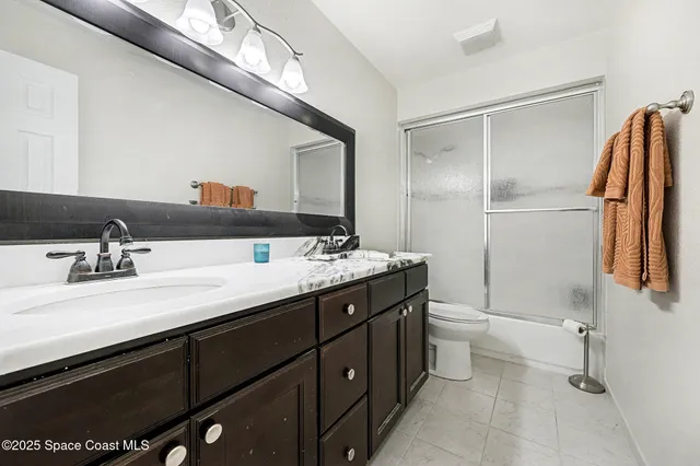 a bathroom with a double vanity sink and mirror