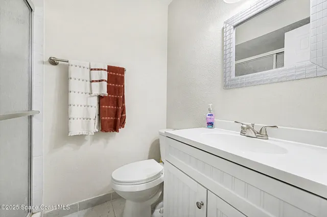 a bathroom with a sink a toilet and mirror