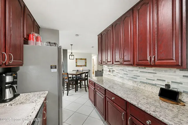 a kitchen with granite countertop a sink appliances and cabinets
